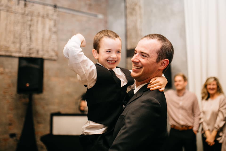 dad holding son dancing